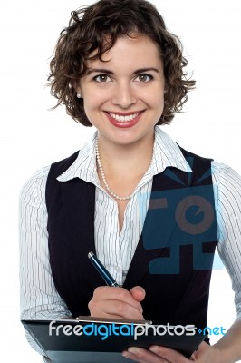 Happy Businesswoman Writing On Clipboard Stock Photo