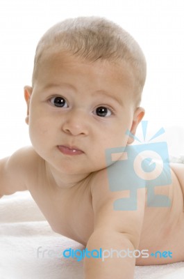 Happy Child Lying And Looking At Camera Stock Photo