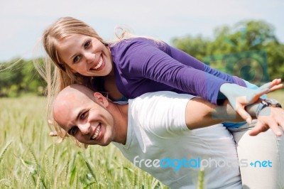 Happy Couple Enjoying With Their Arms Outstreched Stock Photo