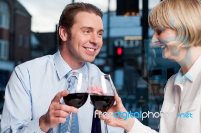 Happy Couple Toasting Wine At A Restaurant Stock Photo