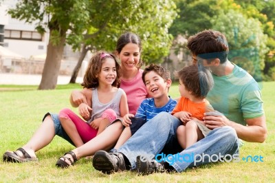 Happy Family Having Fun In The Park Stock Photo