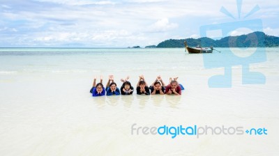 Happy Family Lying Together On The Beach, Thailand Stock Photo