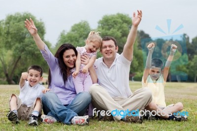 Happy Family Of Five Having Fun By Raising Hands Stock Photo