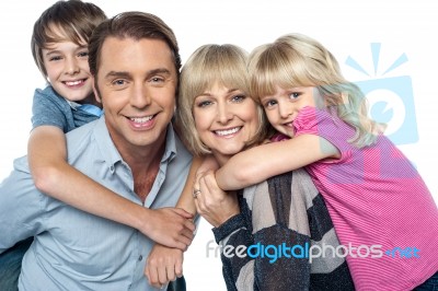 Happy Family Of Four Members Posing Together Stock Photo