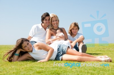 Happy Family On Grass Stock Photo