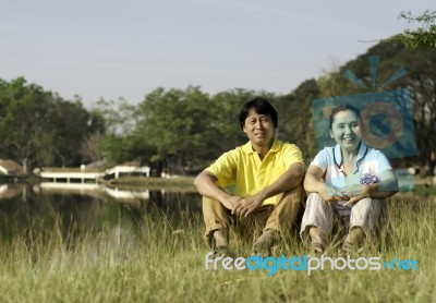 Happy Family Posing For A Portrait In The Park Stock Photo