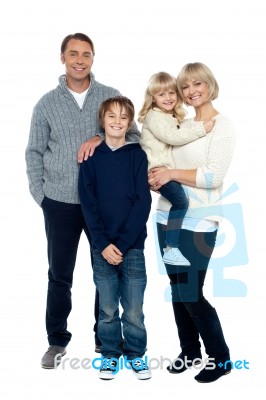 Happy Family Posing In Trendy Winter Wear Outfits Stock Photo