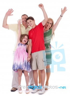 Happy Family Raising Their Hands And Having Fun Stock Photo