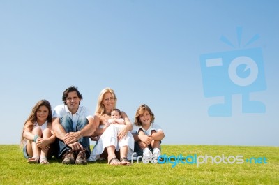 Happy Family Relaxing In Garden Stock Photo