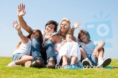 Happy Family Relaxing In Garden Stock Photo