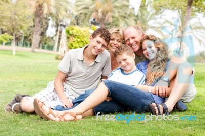 Happy Family Relaxing In The Park Stock Photo