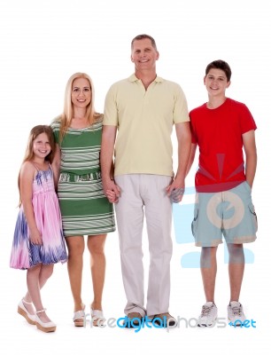 Happy Family Standing By Holding Their Hands Stock Photo