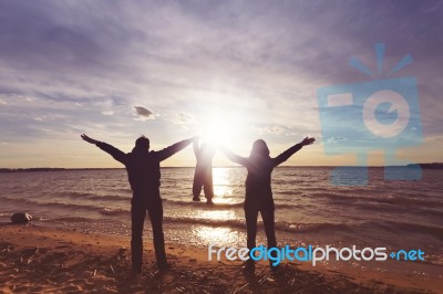 Happy Family With A Baby At The Sunset Stock Photo