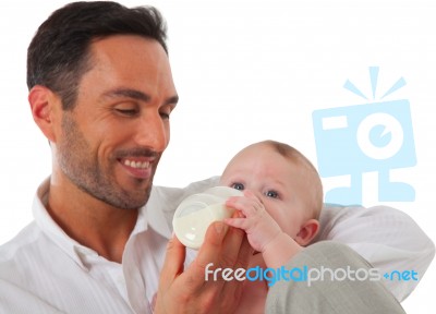 Happy Father Feeding Baby Boy With Milk Bottle Stock Photo