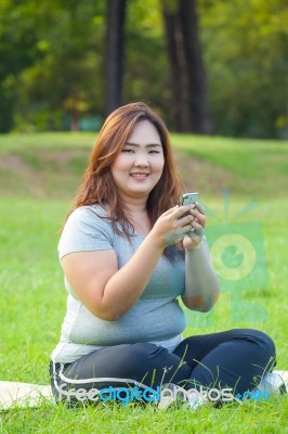 Happy Fat Woman Using Mobile Phone Stock Photo