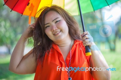 Happy Fatty Woman With Umbrella Stock Photo