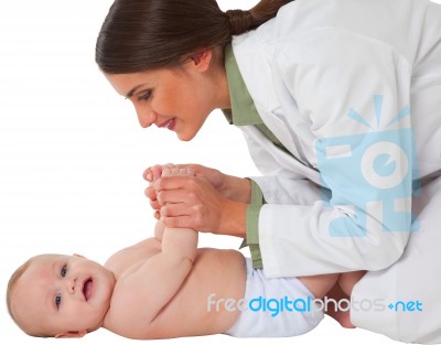 Happy Female Pediatrician Playing With Toddler Stock Photo