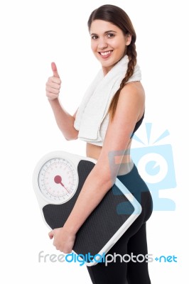 Happy Fitness Woman With A Weighing Scale Stock Photo