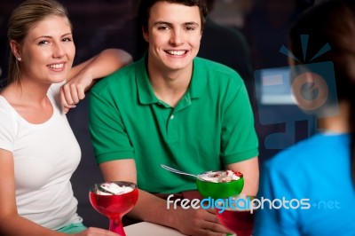 Happy Friends Enjoying Tempting Dessert Stock Photo