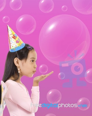 Happy Girl Blowing Bubbles Stock Photo