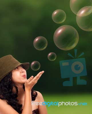 Happy Girl Blowing Some Bubbles Stock Photo