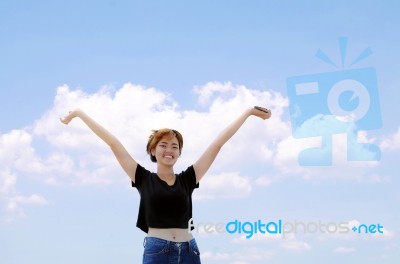 Happy Girl On Blue Sky Background Stock Photo