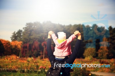 Happy Little Girl Sitting On Father Neck Stock Photo