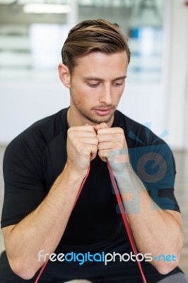 Happy Man Doing Stretching Exercises In A Health Club Stock Photo