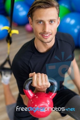 Happy Man Doing Stretching Exercises In A Health Club Stock Photo