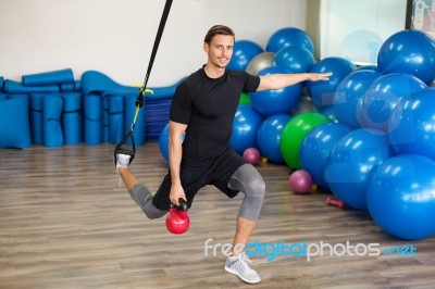 Happy Man Doing Stretching Exercises In A Health Club Stock Photo