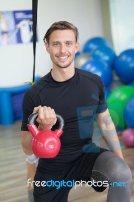 Happy Man Doing Stretching Exercises In A Health Club Stock Photo