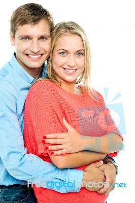 Happy Man Embracing His Wife From Behind Stock Photo