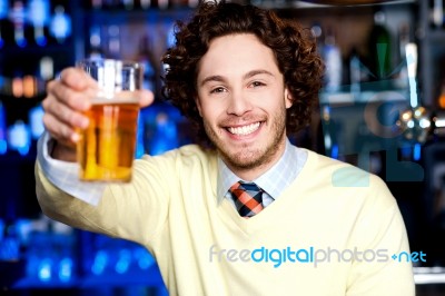 Happy Man Offering Glass Of Beer, Let's Celebrate Stock Photo