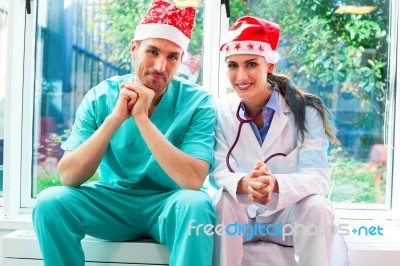 Happy Medical Team Wearing Santa Hats Stock Photo