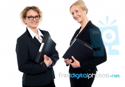 Happy Middle Aged Business Females Holding Files Stock Photo