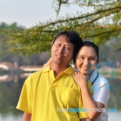 Happy Mother And Father In The Park Stock Photo