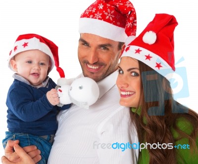 Happy Parents With Baby Boy Wearing Santa Hats Stock Photo