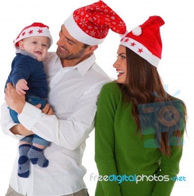 Happy Parents With Son Wearing Santa Hats Stock Photo