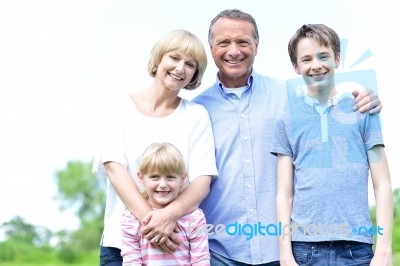 Happy Parents With Their Kids, Outdoors Stock Photo