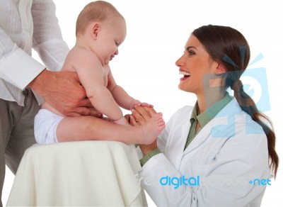 Happy Pediatrician Checking Baby Being Held By Father Stock Photo