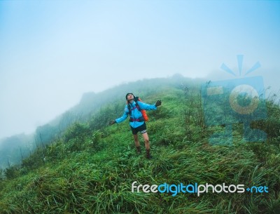 Happy People  With Arms Raised Up And  Enjoying  Beautiful Tropical Rainforest At And Beautiful Mountain Background  With  Nature Landscape Stock Photo