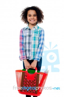 Happy School Girl Carrying Stationery In Basket Stock Photo