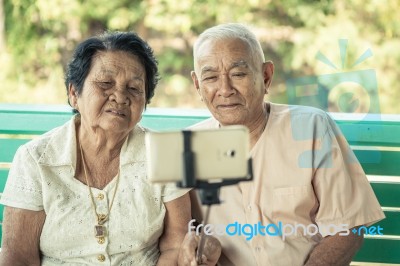 Happy Senior Couple Posing For A Selfie Stock Photo