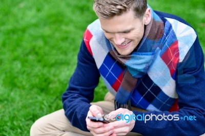 Happy Smiling Man Using Mobile Phone On Park Stock Photo