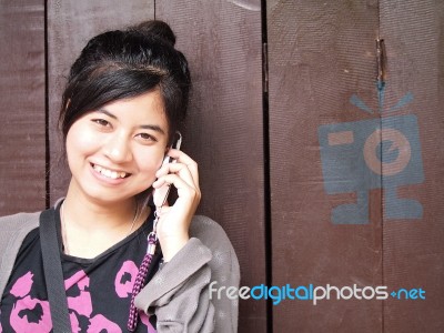 Happy Smiling Teenage Girl With The Mobile Phone Stock Photo