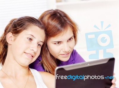 Happy Teenage Girls Using Touchpad Stock Photo