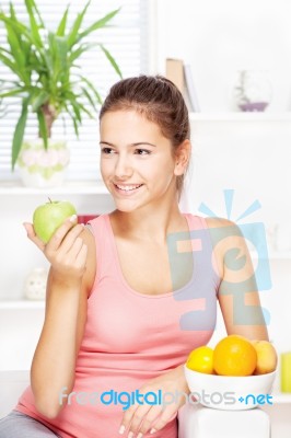 Happy Woman At Home With Fruits Stock Photo