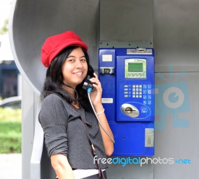 Happy Woman Calling From Public Phone Stock Photo