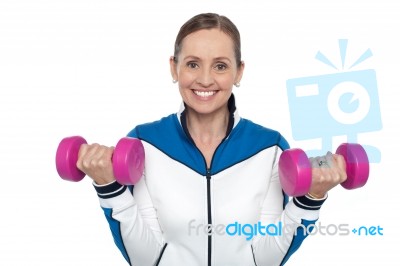 Happy Woman Carrying Dumbbells In Both Hands Stock Photo