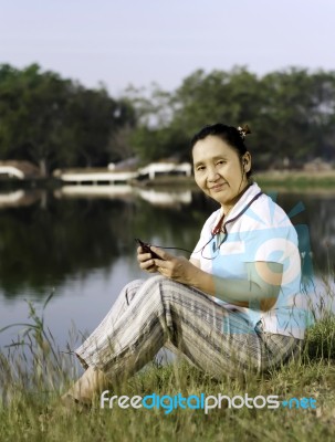 Happy Woman Listening To Music Outdoors Stock Photo